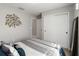 Cozy bedroom with closet and decorative tree art piece, offering a relaxing retreat at 3211 Sweet Acres Pl, St Cloud, FL 34772