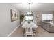 Dining room features a white table, modern chandelier, and an adjacent sitting room at 3211 Sweet Acres Pl, St Cloud, FL 34772