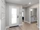 Bright entryway featuring wood floors, a decorative rug, and a glass front door at 3211 Sweet Acres Pl, St Cloud, FL 34772