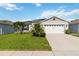 Charming single-story home with well-manicured lawn and two-car garage at 3211 Sweet Acres Pl, St Cloud, FL 34772