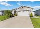 Charming single-story home with well-manicured lawn and two-car garage at 3211 Sweet Acres Pl, St Cloud, FL 34772