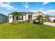 Beautiful single-story home featuring a lush green lawn and a two-car garage at 3211 Sweet Acres Pl, St Cloud, FL 34772
