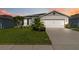 Charming single-story home with well-manicured lawn and two-car garage at 3211 Sweet Acres Pl, St Cloud, FL 34772