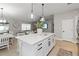 Spacious kitchen with a large island, stylish pendant lighting, and an open view to the living room at 3211 Sweet Acres Pl, St Cloud, FL 34772