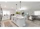Modern kitchen featuring a large island, white cabinets, and stainless steel appliances at 3211 Sweet Acres Pl, St Cloud, FL 34772
