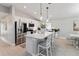 Bright kitchen features a large island with white cabinets, stainless steel appliances, and modern pendant lighting at 3211 Sweet Acres Pl, St Cloud, FL 34772
