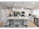 Kitchen featuring a large center island with modern pendant lighting, white cabinets, and stainless steel appliances at 3211 Sweet Acres Pl, St Cloud, FL 34772