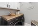 Well-organized laundry room with modern washer, dryer, and ample storage cabinets at 3211 Sweet Acres Pl, St Cloud, FL 34772
