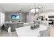 Open-concept living room with a dining area, kitchen, and a large sectional sofa at 3211 Sweet Acres Pl, St Cloud, FL 34772