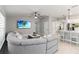 Bright living room boasting a large sectional sofa, modern ceiling fan, and open layout at 3211 Sweet Acres Pl, St Cloud, FL 34772