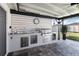 Outdoor kitchen complete with stainless steel grill, sink, storage, and beverage cooler at 3211 Sweet Acres Pl, St Cloud, FL 34772