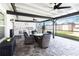 Covered patio with outdoor kitchen, ceiling fans, and comfortable seating area at 3211 Sweet Acres Pl, St Cloud, FL 34772