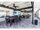 Expansive screened patio featuring an outdoor kitchen, dining table, and seating area with a TV at 3211 Sweet Acres Pl, St Cloud, FL 34772