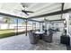 Screened patio with comfortable seating and ceiling fans, perfect for outdoor living at 3211 Sweet Acres Pl, St Cloud, FL 34772