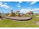 Community playground featuring a variety of play equipment and a shaded seating area at 3211 Sweet Acres Pl, St Cloud, FL 34772