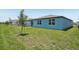 Back exterior of a single-story home with sliding glass door and lawn at 3214 Viceroy Ct, Kissimmee, FL 34759