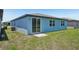 Exterior shot of a single-story home showing the sliding glass door leading to the backyard at 3214 Viceroy Ct, Kissimmee, FL 34759