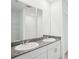 Bright bathroom featuring double sinks, granite counters, and ample vanity storage at 3214 Viceroy Ct, Kissimmee, FL 34759