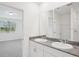 Bathroom featuring double sinks, granite counters, and a walk-in shower at 3214 Viceroy Ct, Kissimmee, FL 34759