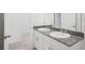 Bright bathroom featuring double sinks, granite counters, and ample vanity storage at 3214 Viceroy Ct, Kissimmee, FL 34759