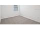 Neutral bedroom featuring carpeted floors, a window and white walls at 3214 Viceroy Ct, Kissimmee, FL 34759