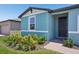 View of the home's front entrance with a brick walkway and attractive landscaping at 3214 Viceroy Ct, Kissimmee, FL 34759