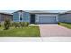 Charming single-story home featuring a well-maintained lawn and a brick-paved driveway at 3214 Viceroy Ct, Kissimmee, FL 34759
