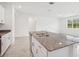 Modern kitchen featuring a granite island with a stainless steel sink and a view of the outdoors at 3214 Viceroy Ct, Kissimmee, FL 34759