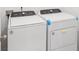 Modern laundry room features new, white front-load washer and dryer at 3214 Viceroy Ct, Kissimmee, FL 34759