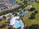 Stunning aerial view showcasing the community pool, golf course, tennis courts, and surrounding neighborhood at 3333 Sagebrush St, Harmony, FL 34773