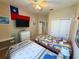 Cozy bedroom with two beds, ceiling fan, and a closet that provides ample storage space at 3333 Sagebrush St, Harmony, FL 34773