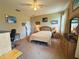 Comfortable bedroom with soft carpet, a queen bed, classic wood furniture, and decor providing a serene atmosphere at 3333 Sagebrush St, Harmony, FL 34773