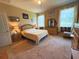 Comfortable bedroom with soft carpet, a queen bed, classic wood furniture, and decor providing a serene atmosphere at 3333 Sagebrush St, Harmony, FL 34773