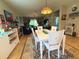 Inviting dining area with a white table, chairs, and rug next to a living room featuring leather furniture and decor at 3333 Sagebrush St, Harmony, FL 34773