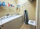 Functional laundry room with modern appliances, and ample shelving for storage at 3333 Sagebrush St, Harmony, FL 34773