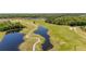Breathtaking aerial view of lush golf course, serene ponds, and upscale community at 3391 Cortland Dr, Davenport, FL 33837
