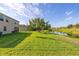Expansive backyard featuring a well-manicured lawn and serene water view at 3391 Cortland Dr, Davenport, FL 33837