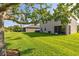Large backyard with well-maintained lawn and mature trees, offering privacy and space for outdoor enjoyment at 3391 Cortland Dr, Davenport, FL 33837