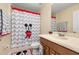 Bathroom featuring a Mickey Mouse themed shower curtain and decor around the vanity at 3391 Cortland Dr, Davenport, FL 33837