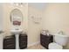 Cozy half bathroom with a pedestal sink, toilet, and modern fixtures, all efficiently arranged at 3391 Cortland Dr, Davenport, FL 33837