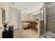 Bathroom with a large soaking tub, a separate glass shower, and a double vanity with granite counters at 3391 Cortland Dr, Davenport, FL 33837