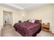 Comfortable bedroom with carpet, a trey ceiling, neutral walls, and bedside tables at 3391 Cortland Dr, Davenport, FL 33837