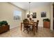 Inviting dining room with a wooden table, chandelier, and natural light from the window at 3391 Cortland Dr, Davenport, FL 33837