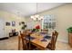 Cozy dining room featuring a wooden table, seating for six, and warm overhead lighting at 3391 Cortland Dr, Davenport, FL 33837