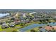Aerial view of a two-story home, highlighting the well-maintained landscaping and community lake at 3391 Cortland Dr, Davenport, FL 33837