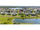 Beautiful two-story home with a well-manicured lawn, lake view, and mature trees at 3391 Cortland Dr, Davenport, FL 33837