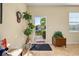 Bright foyer with tiled floors, a view to the front yard, and charming decorative touches at 3391 Cortland Dr, Davenport, FL 33837