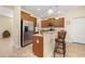 Modern kitchen with stainless steel refrigerator, granite countertops, and a breakfast bar at 3391 Cortland Dr, Davenport, FL 33837