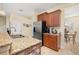 Open kitchen area with granite countertops, stainless steel appliances, and tile flooring at 3391 Cortland Dr, Davenport, FL 33837