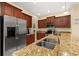 Well-equipped kitchen featuring stainless steel appliances and luxurious granite countertops at 3391 Cortland Dr, Davenport, FL 33837